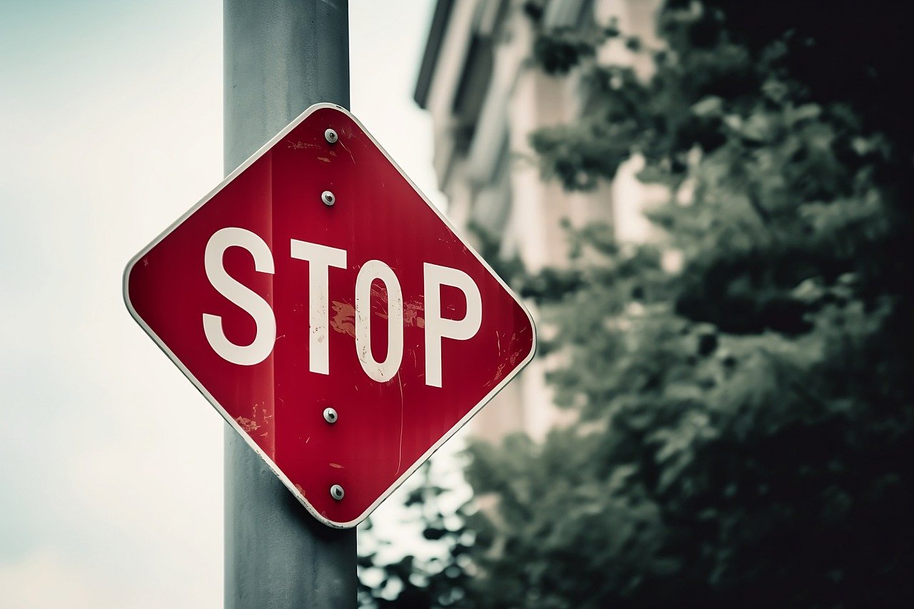 An AI generated image of a stop sign that uses the wrong shape (a diamond) and has an uneven O in the middle of the word STOP